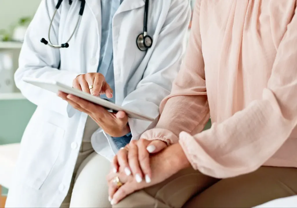 Is an STI Checkup Different From an STD Checkup? 3 STI check up doctor discussing sexual health screening results with a patient during a confidential medical consultation.